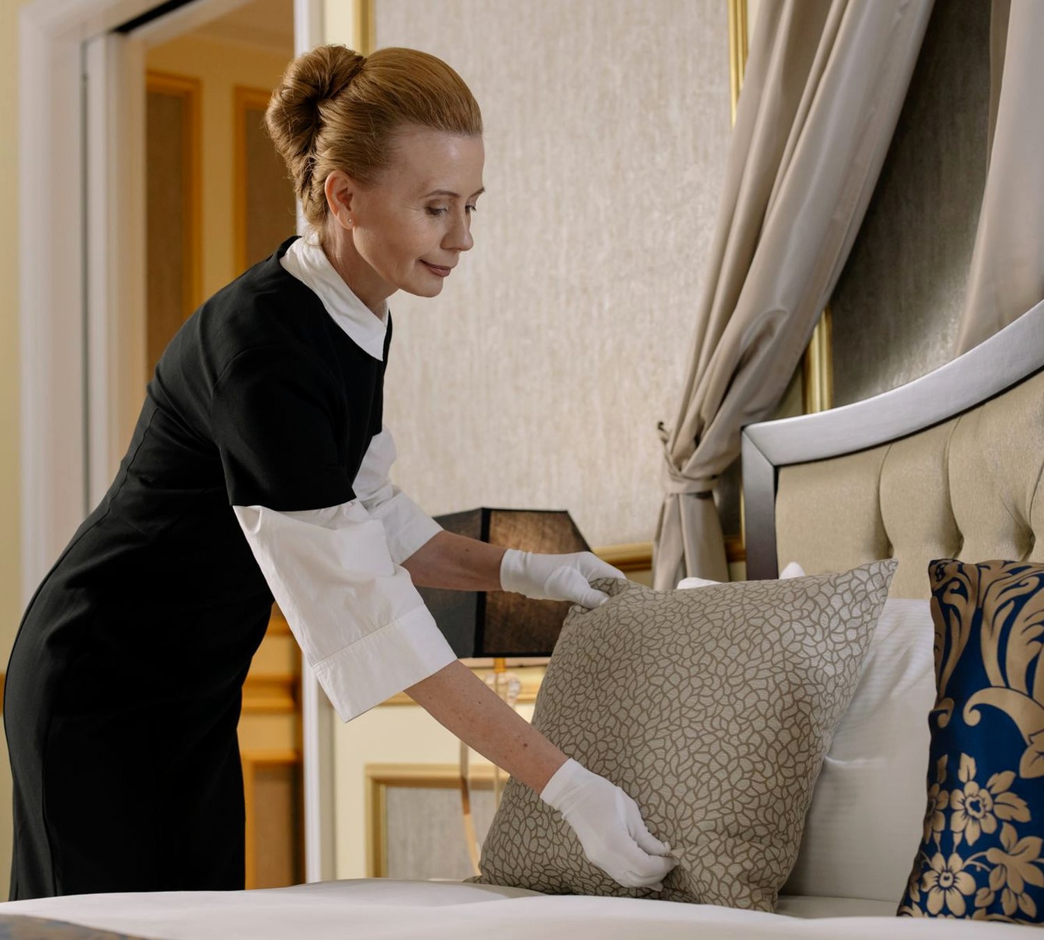 Housekeeping staff finishing a room to hotel standard, the standard East Cleaning was trained on