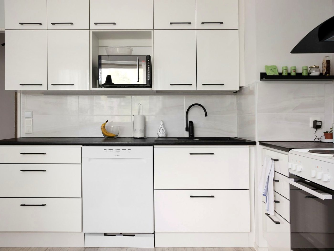 Clean white kitchen cabinet fronts and appliance faces