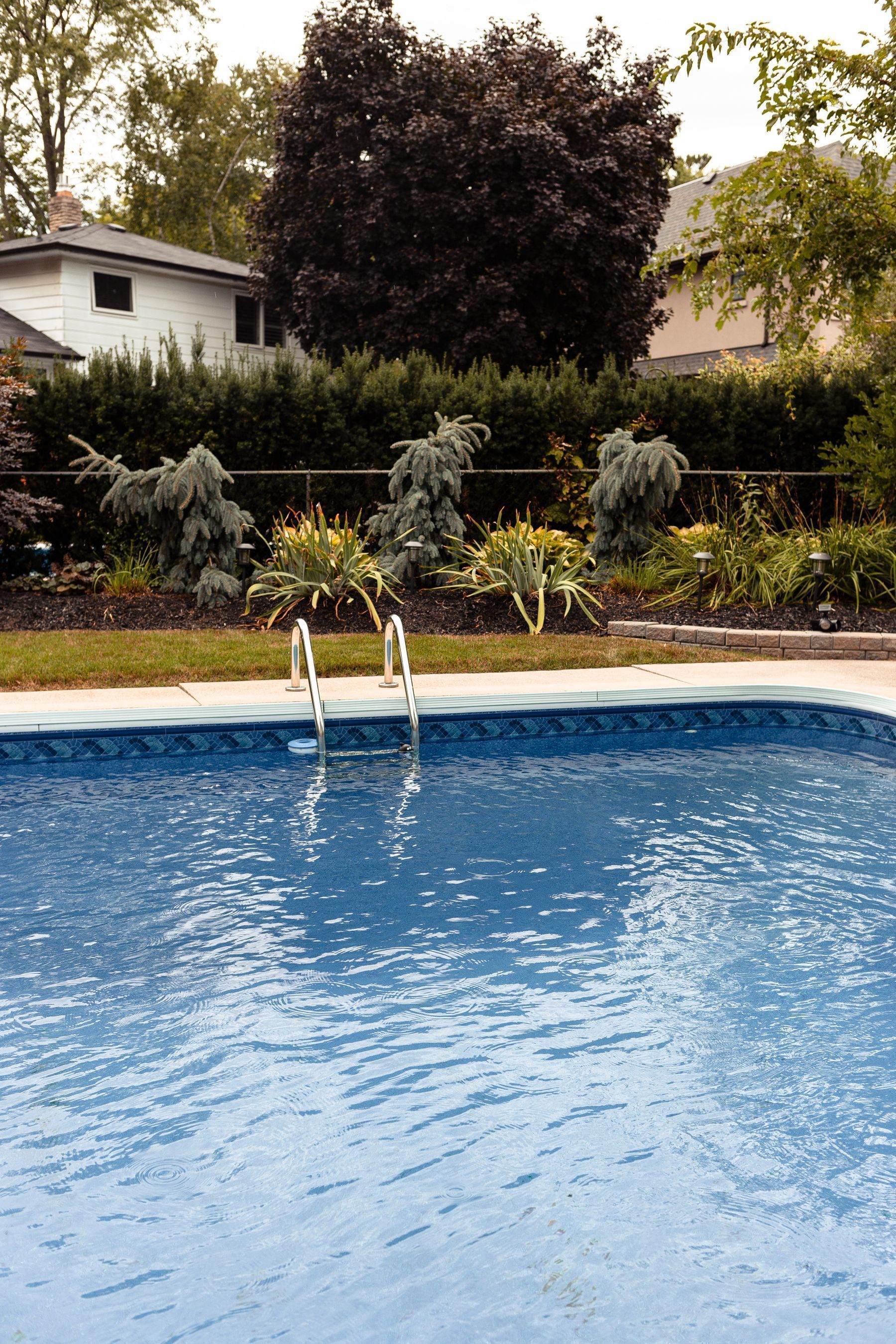A well-kept backyard pool with clear water